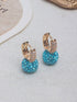 A pair of simple, elegant pendant earrings adorned with red rhinestones for women