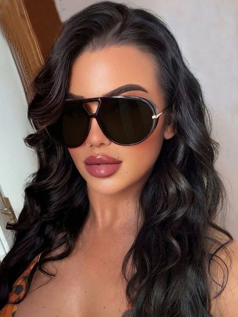 Woman wearing sunglasses with a neutral background