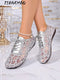 A pair of women's lace-up shoes with a silver glittery geometric mesh pattern, shown on a model's feet against a marble floor and decorative background. The brand name 'JIANCHAO' is visible in the top left corner.