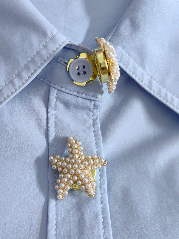 Pearl star-shaped button on a light blue shirt