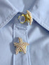 Pearl star-shaped button on a light blue shirt