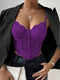 Purple lace top worn under a black blazer with a neutral background