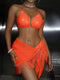 Person wearing an orange bikini with fringes on a dark background