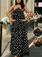 Woman wearing a black polka dot dress with a close-up inset of the dress.