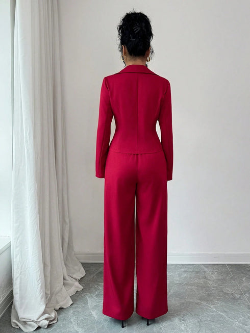 Person wearing a red suit standing in a room with white curtains and light gray floor.SHEIN Elenzya Women's Lapel Collar Slim Fit Blazer Jacket And Flared Suit Pants 2 Pieces Set2
