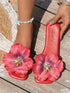 Red sandals with floral design on a wooden floor