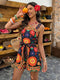 Woman in a colorful dress holding an orange in a rustic setting