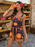Woman in a colorful dress holding an orange in a rustic setting