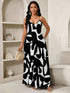 Woman wearing a black and white patterned dress in an indoor setting.