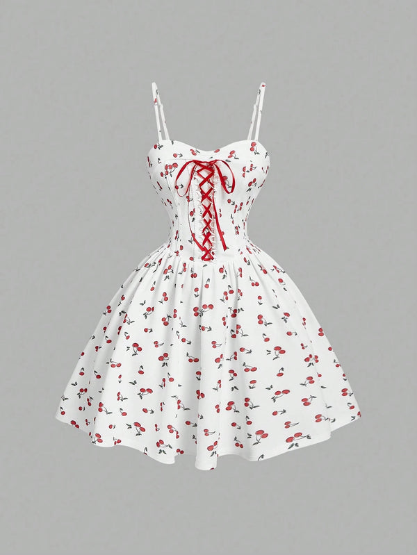 White dress with red floral pattern and lace-up front on a gray background