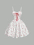 White dress with red floral pattern and lace-up front on a gray background