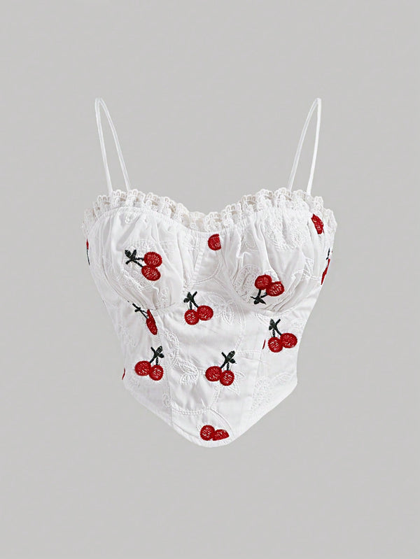 White lace top with cherry embroidery on a gray background