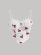 White lace top with cherry embroidery on a gray background