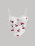 White lace top with cherry embroidery on a gray background