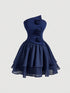 A navy blue one-shoulder dress with a structured corset-style bodice, three dimensional fabric roses on the front, and a layered ruffled skirt, shown against a light gray background.