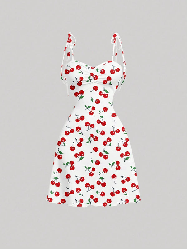 White dress with red cherry pattern on a gray background