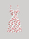White dress with red cherry pattern on a gray background