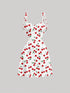 White dress with red cherry pattern on a gray background