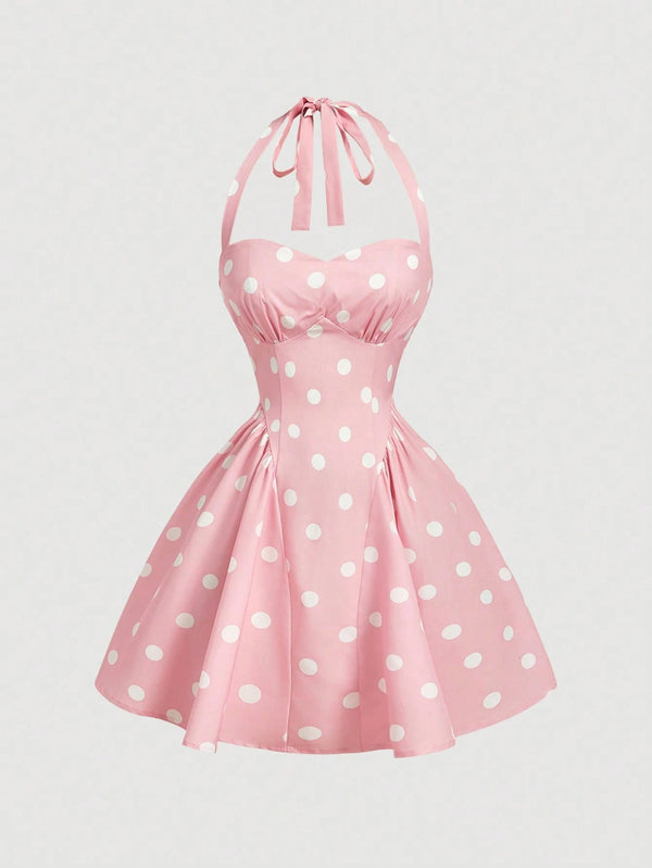 Pink dress with white polka dots on a light gray background