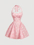 Pink dress with white polka dots on a light gray background