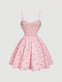 Pink dress with floral pattern on a light gray background