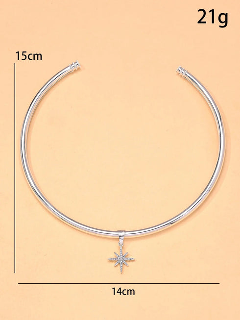 Silver necklace with a star pendant on a beige background