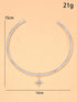 Silver necklace with a star pendant on a beige background