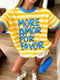 A woman wearing a yellow and white striped ringer t-shirt with blue trim and the text 'MORE AMOR POR FAVOR' in blue letters, paired with white shorts and holding a blue purse.
