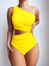 A woman wearing a bright yellow one-shoulder swimsuit with a side cutout, photographed against a plain light gray studio background.