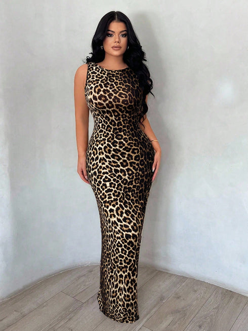 Woman wearing a leopard print dress against a plain background