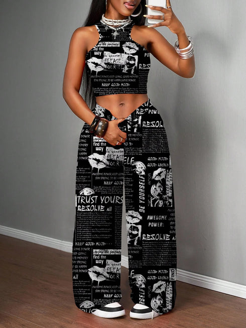 Woman wearing a black and white patterned outfit against a gray wall.