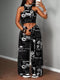 Woman wearing a black and white patterned outfit against a gray wall.