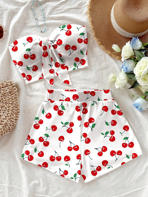 White outfit with red cherry pattern on a light background