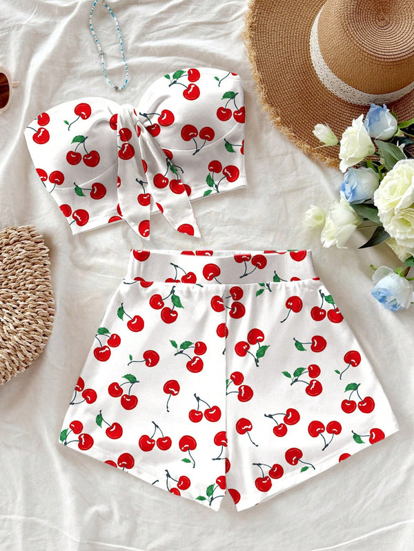 White outfit with red cherry pattern on a light background