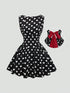 A sleeveless black and white polka dot swing dress with a red bow accent, shown on a light gray background with a circular inset highlighting the red bow.