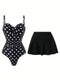 A two-piece swimsuit set featuring a black one-piece swimsuit with white polka dots and a solid black pleated mini skirt, displayed against a plain white background.