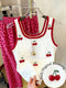 White tank top with red cherry design and pink leopard print pants on a hanger.