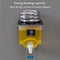 Yellow oil dispenser with metal weight on a gray background