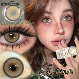 Person wearing lemon brown contact lenses with close-up of lenses and product packaging.