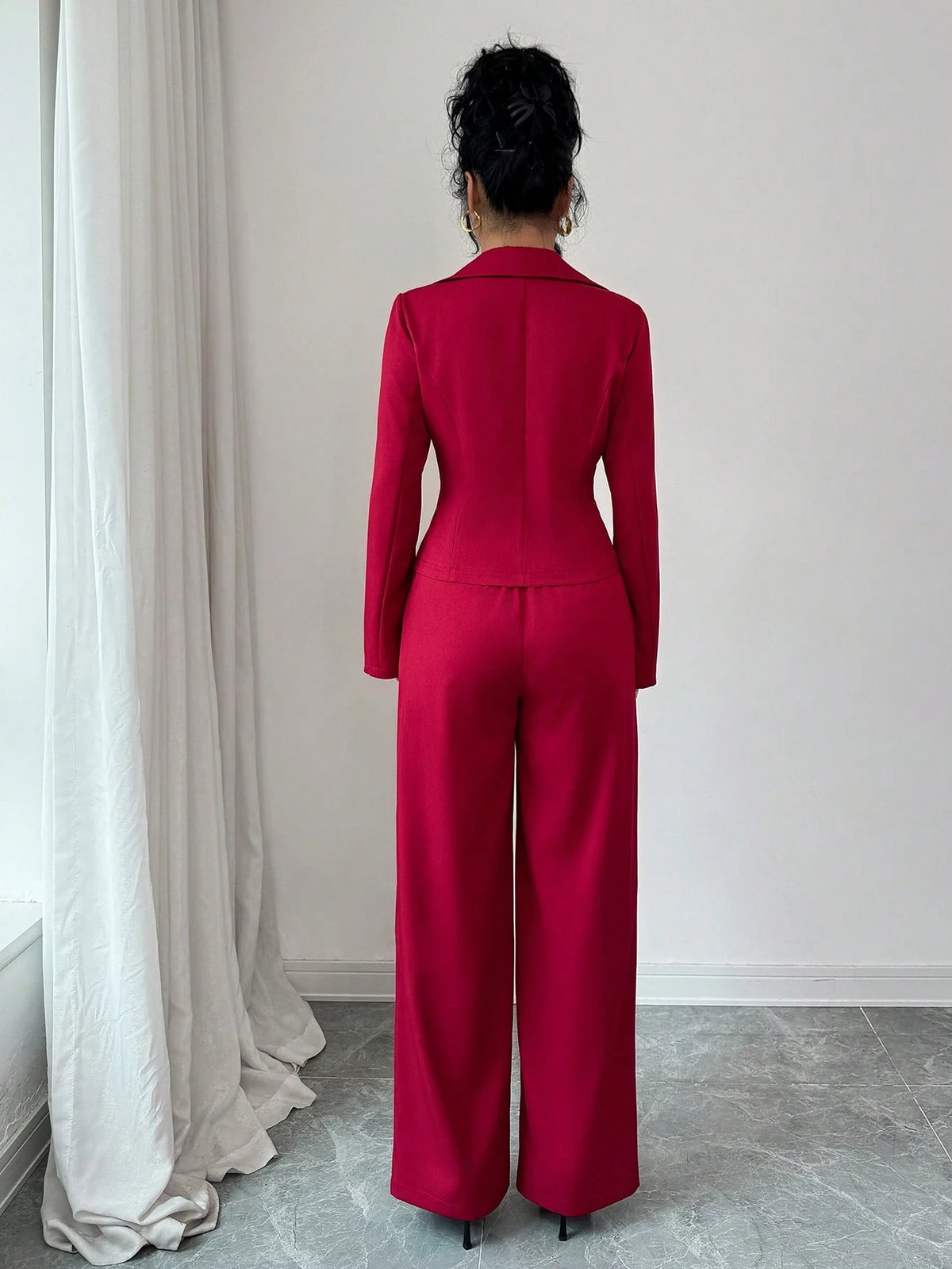 Person wearing a red suit standing in a room with white curtains and light gray floor.SHEIN Elenzya Women's Lapel Collar Slim Fit Blazer Jacket And Flared Suit Pants 2 Pieces Set2