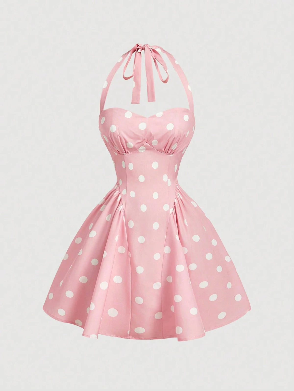 Pink dress with white polka dots on a light gray background