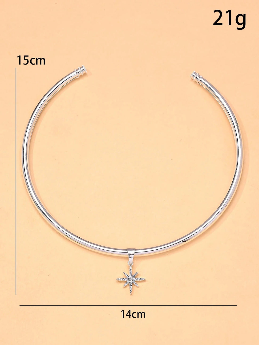 Silver necklace with a star pendant on a beige background