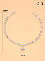Silver necklace with a star pendant on a beige background