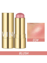 A gold cosmetic blush stick shown open next to its cap, with a swatch of the pink blush shade and the text 'BLUSH' and '03#' on a white background.