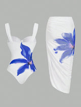 White swimsuit with blue floral design on a gray background