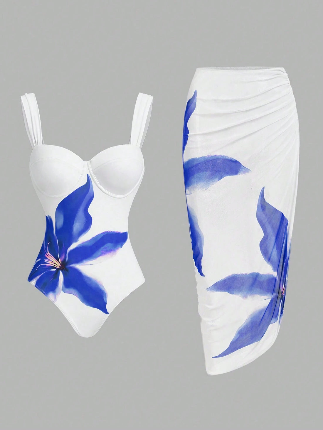 White swimsuit with blue floral design on a gray background