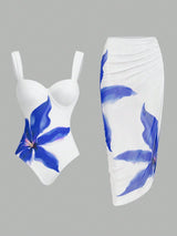 White swimsuit with blue floral design on a gray background